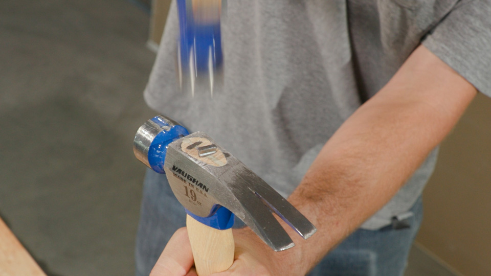 hammering the second steel wedge into the handle